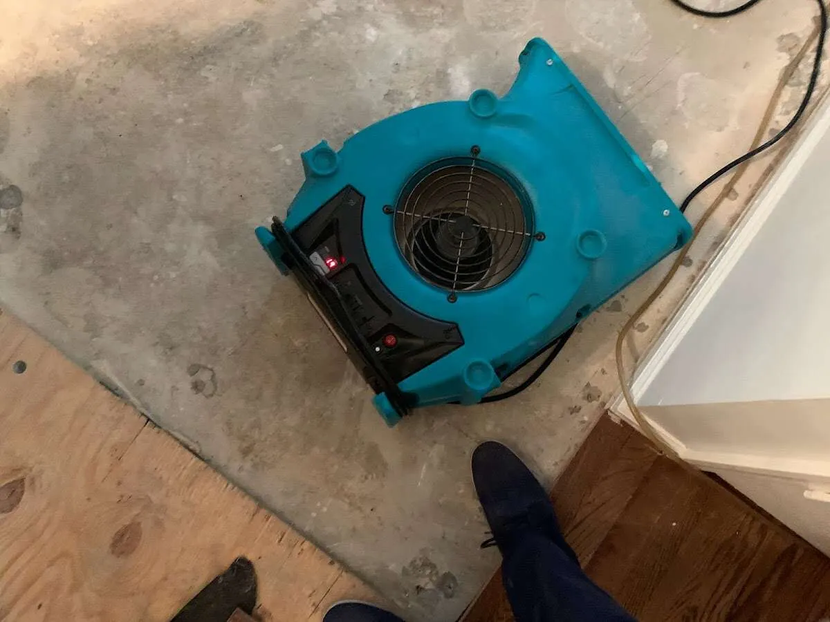 Air mover drying subfloor during Commercial Water Damage Restoration in St. Charles